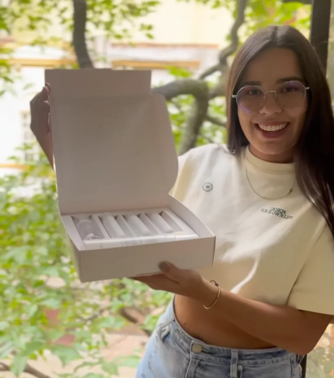 Custom Packaging 1 Woman holding an open white custom box with the product inside